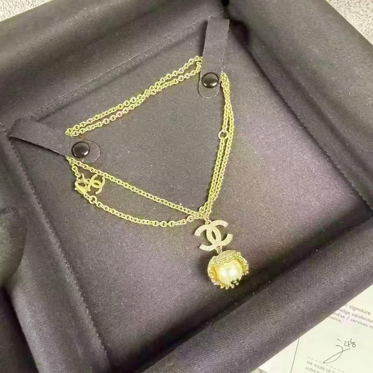 Chanel - Other - Gold-tone metal with a pearl-style pendant and clear decorative stones. - Gold
