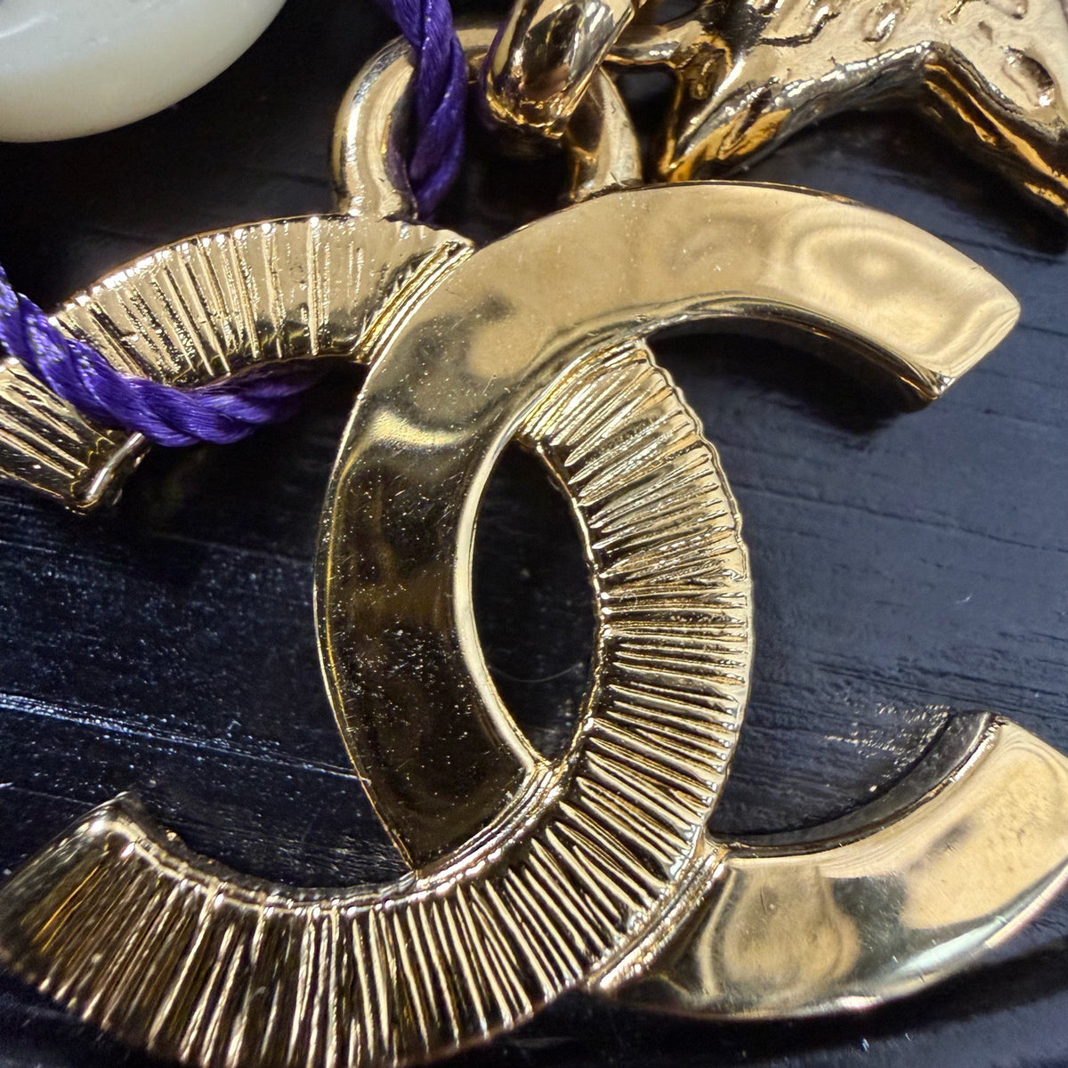 Chanel - Other - Gold-tone metal with black enamel accents. - Gold