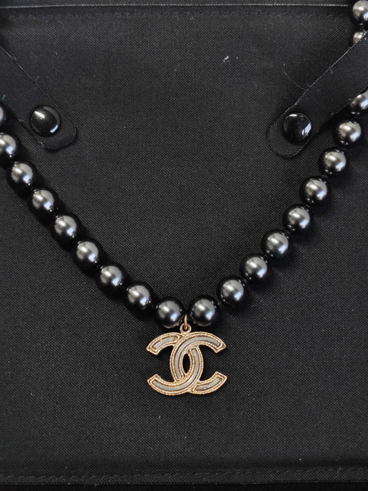 Chanel - Other - Gold-tone metal with black faux-pearl beads. - Black