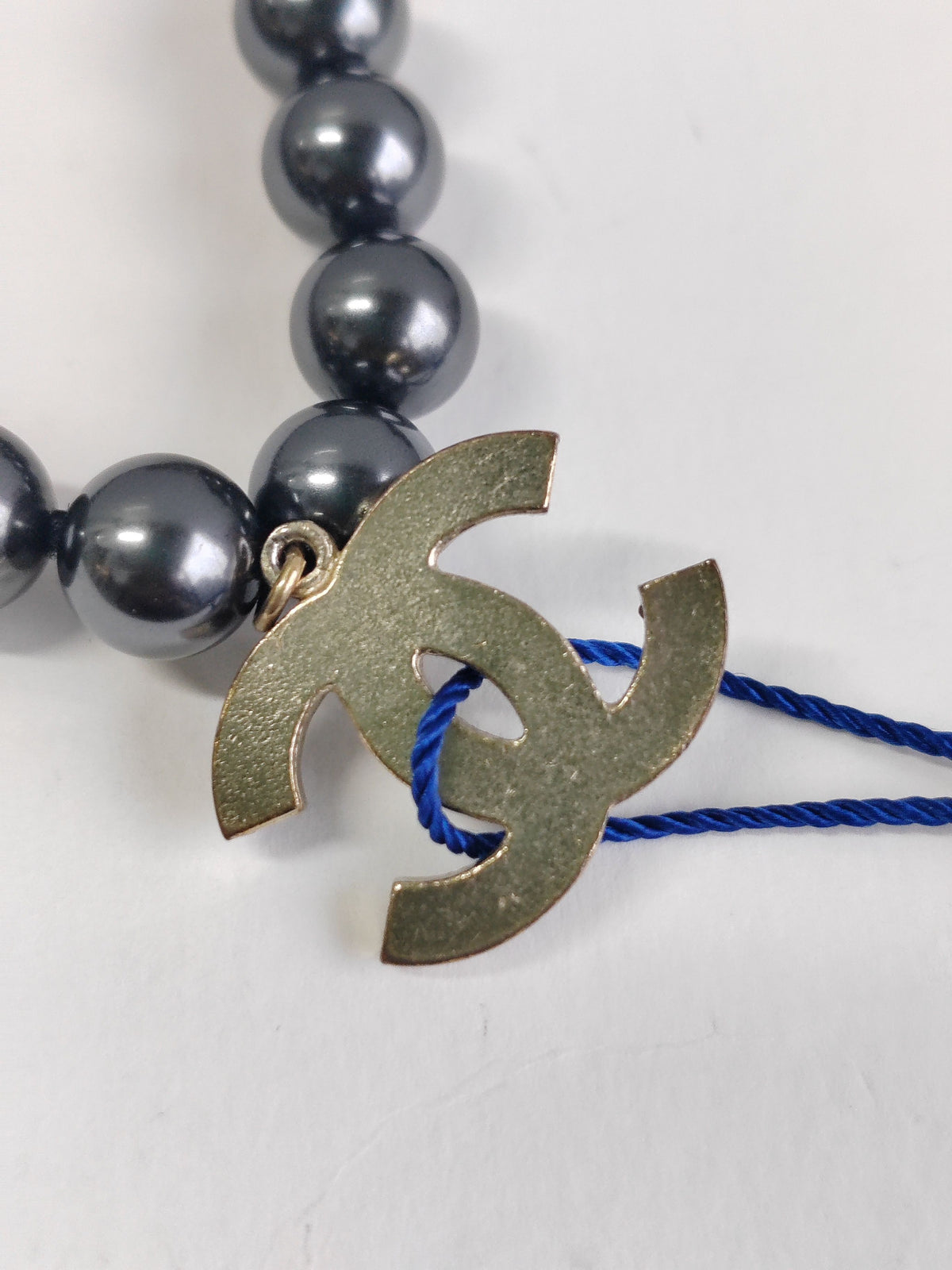 Chanel - Other - Gold-tone metal with black faux-pearl beads. - Black