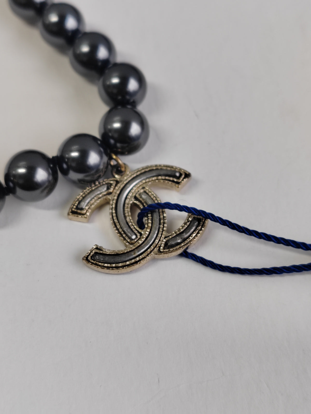 Chanel - Other - Gold-tone metal with black faux-pearl beads. - Black