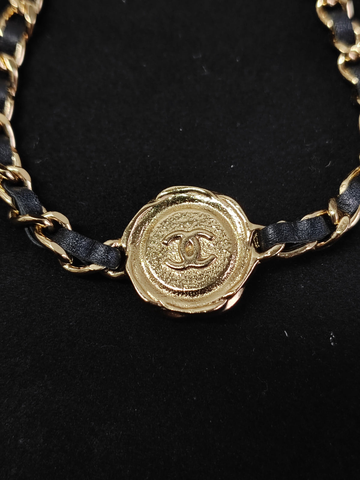 Chanel - Other - Gold-tone metal with black leather woven through the chain and a black centre detail. - Black