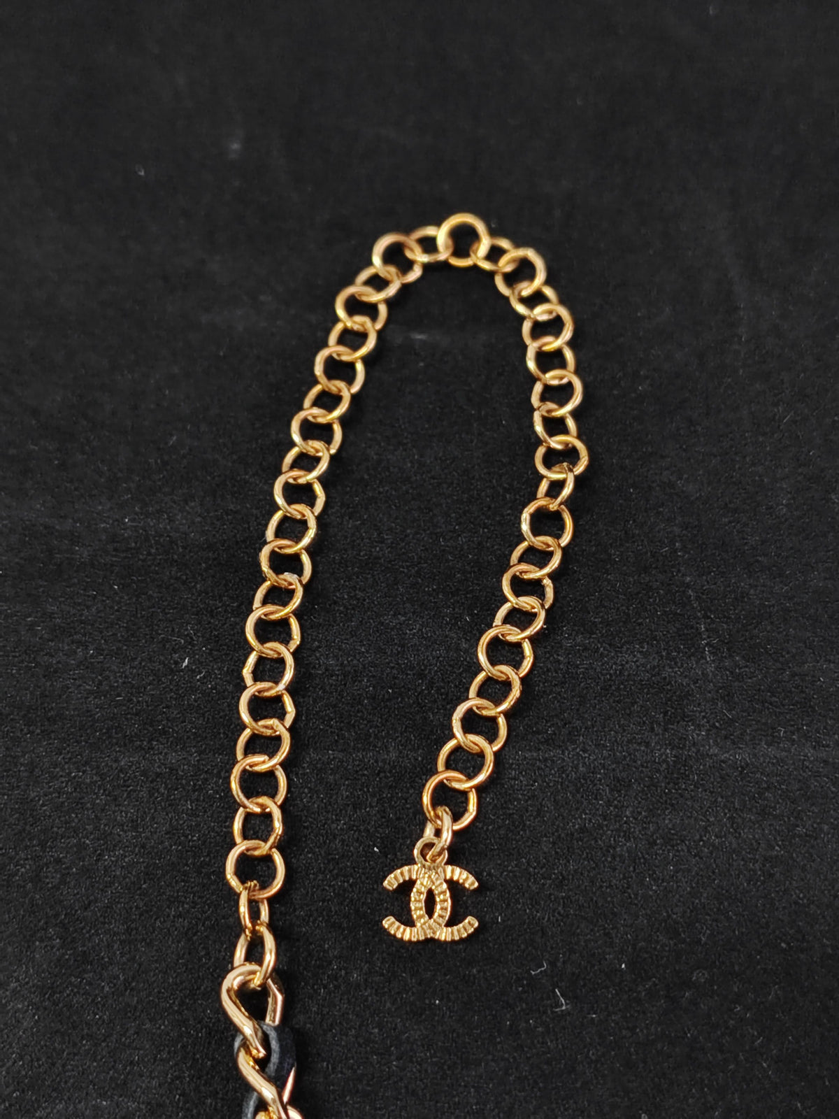 Chanel - Other - Gold-tone metal with black leather woven through the chain and a black centre detail. - Black