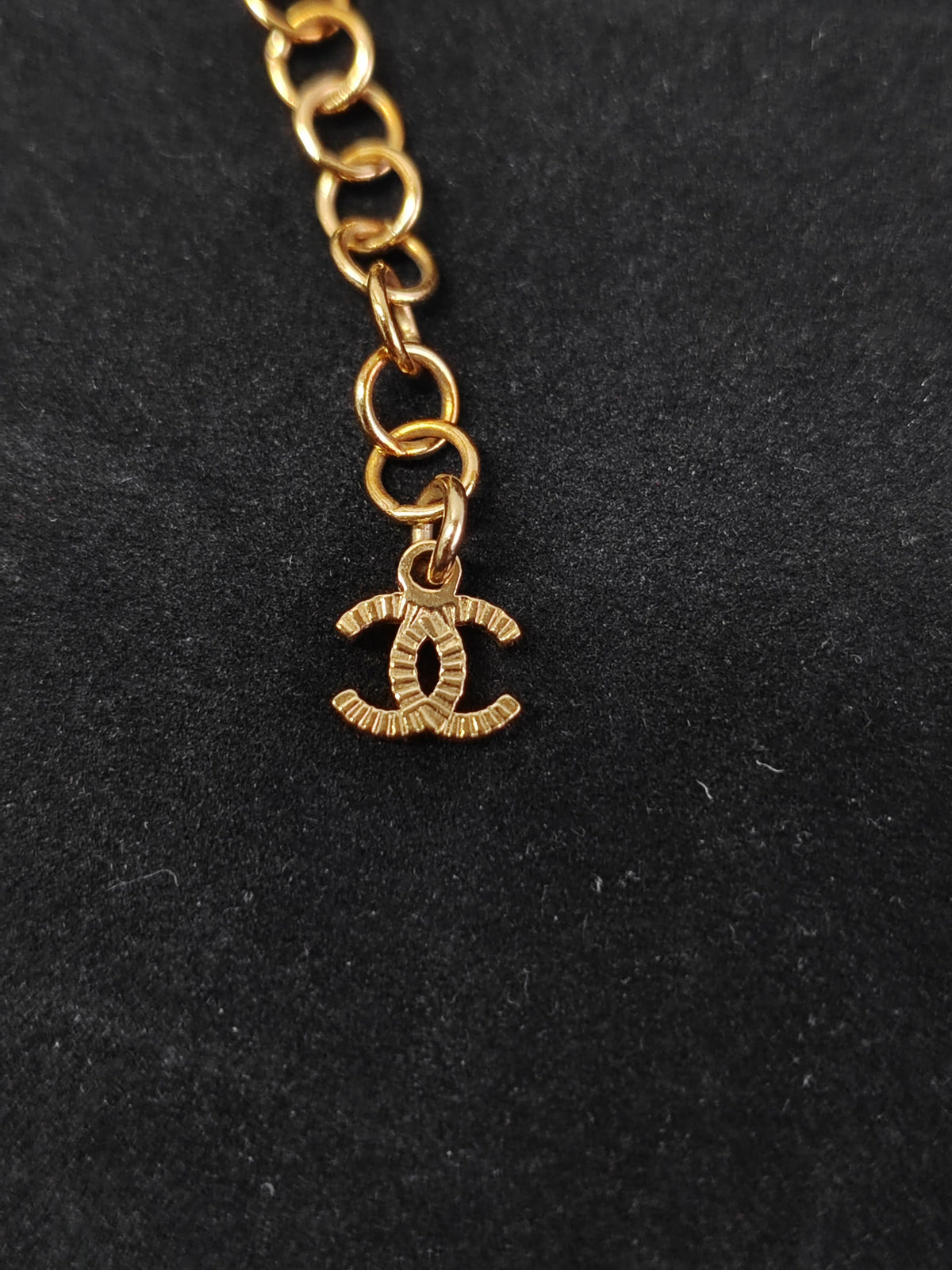 Chanel - Other - Gold-tone metal with black leather woven through the chain and a black centre detail. - Black