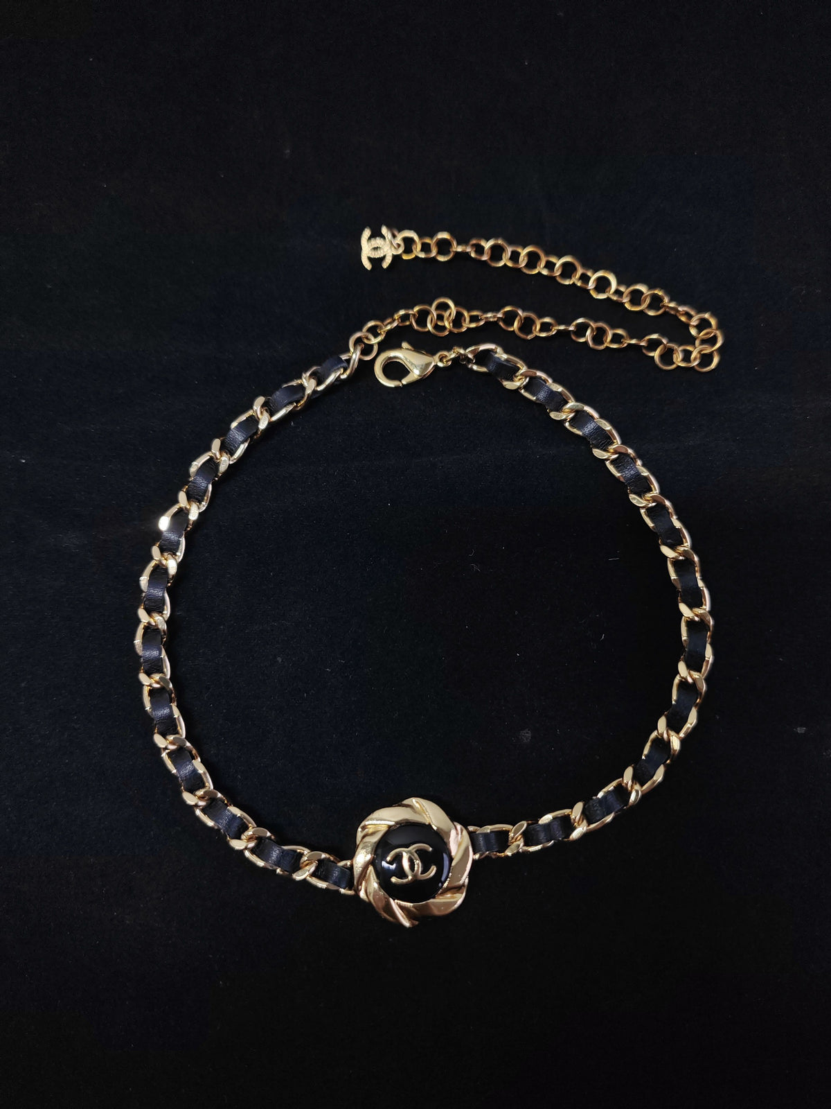 Chanel - Other - Gold-tone metal with black leather woven through the chain and a black centre detail. - Black