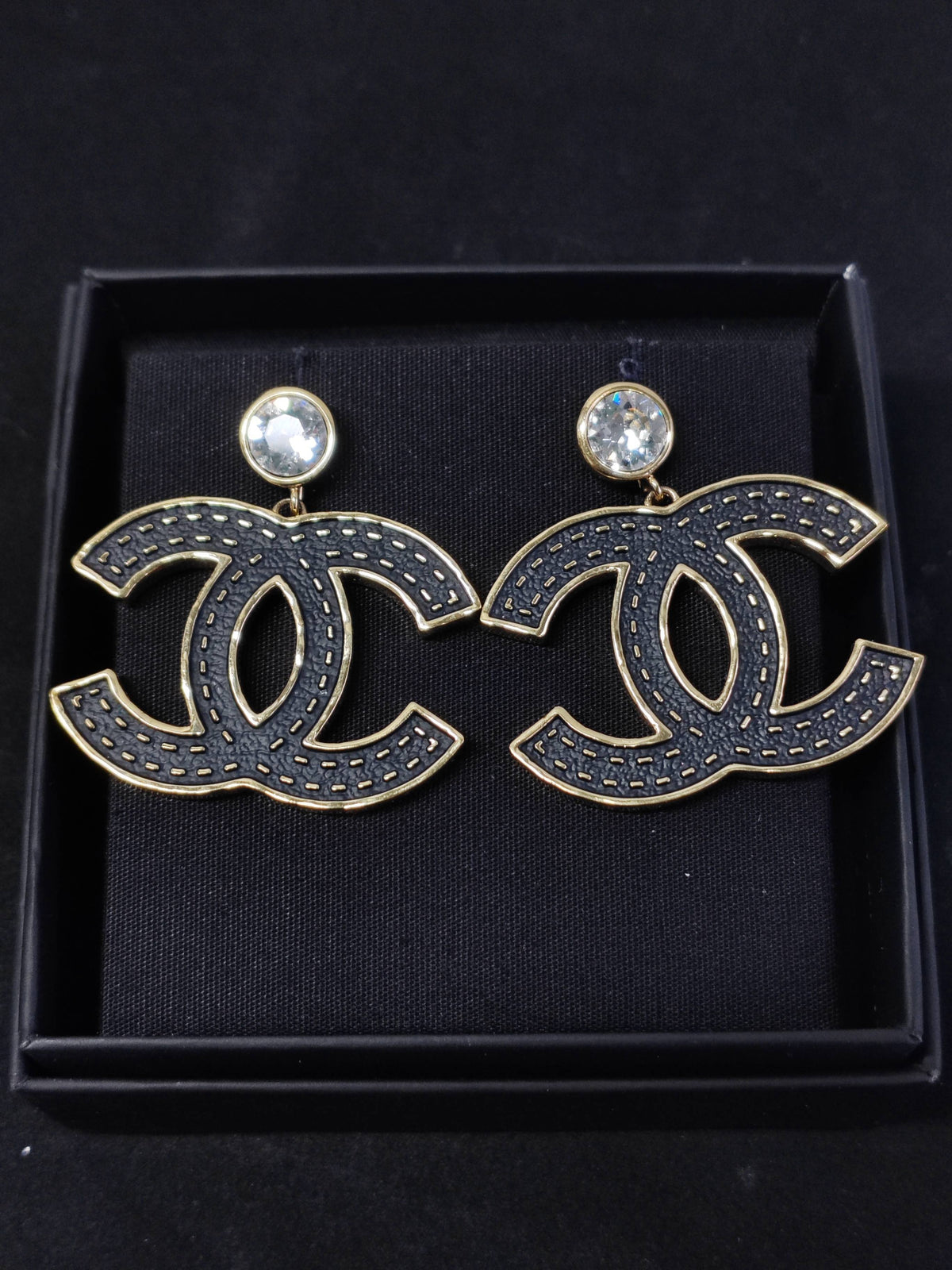 Chanel - Other - Gold-tone metal with black textured decorative panels and clear crystal-like accents; exact composition of the decorative elements is unconfirmed. - Black