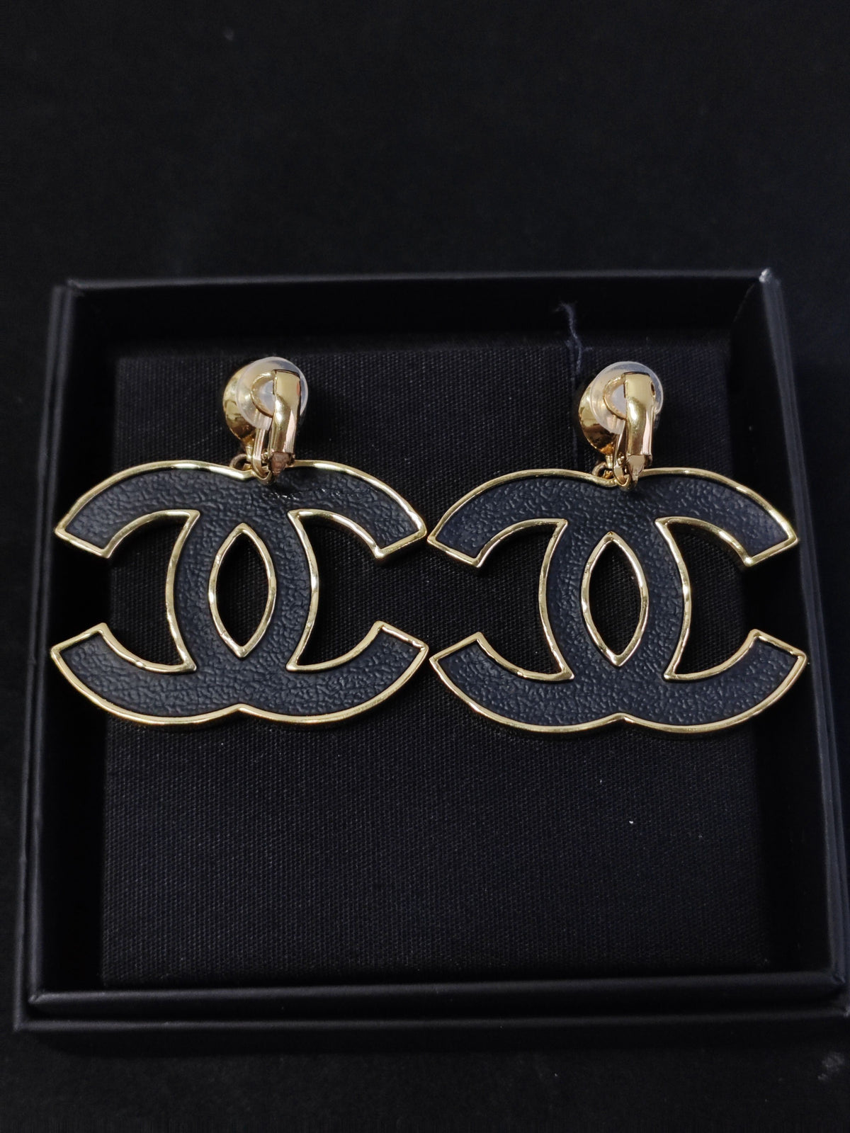 Chanel - Other - Gold-tone metal with black textured decorative panels and clear crystal-like accents; exact composition of the decorative elements is unconfirmed. - Black
