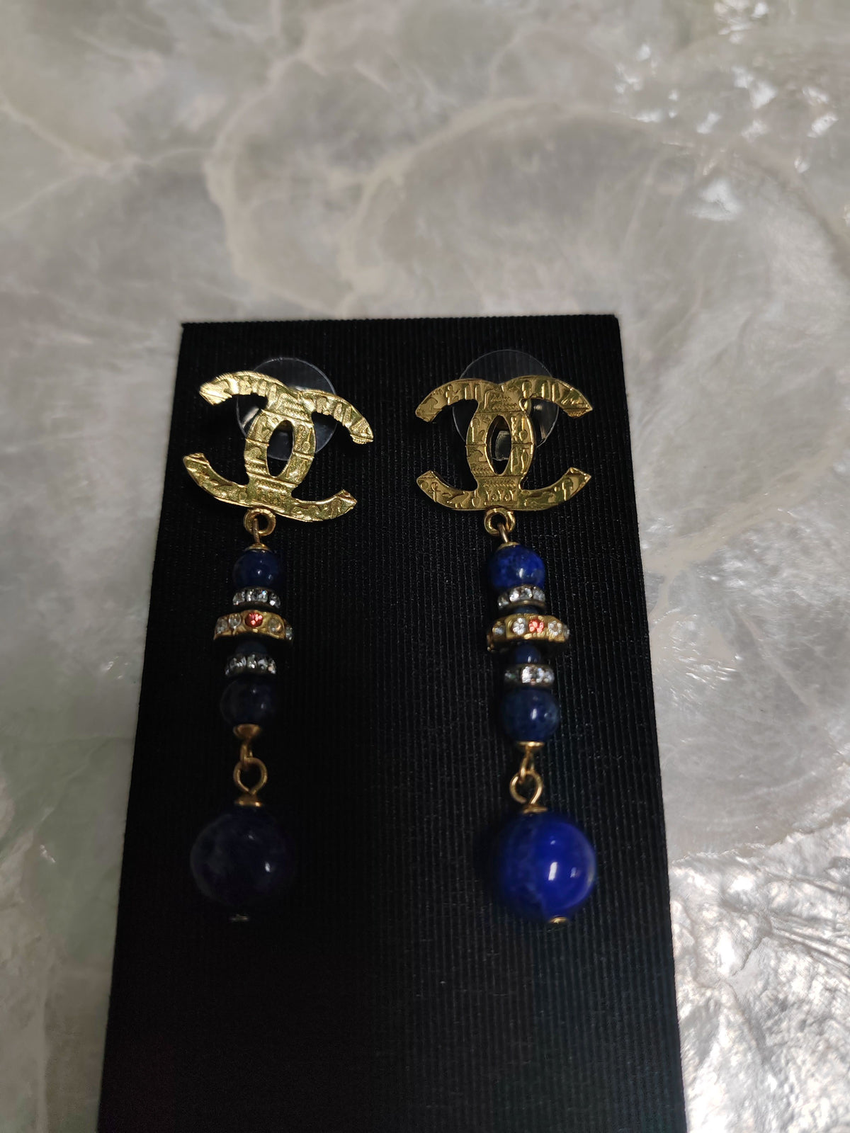 Chanel - Other - Gold-tone metal with blue bead drops and crystal-like accents; exact composition is unconfirmed. - Multicolour