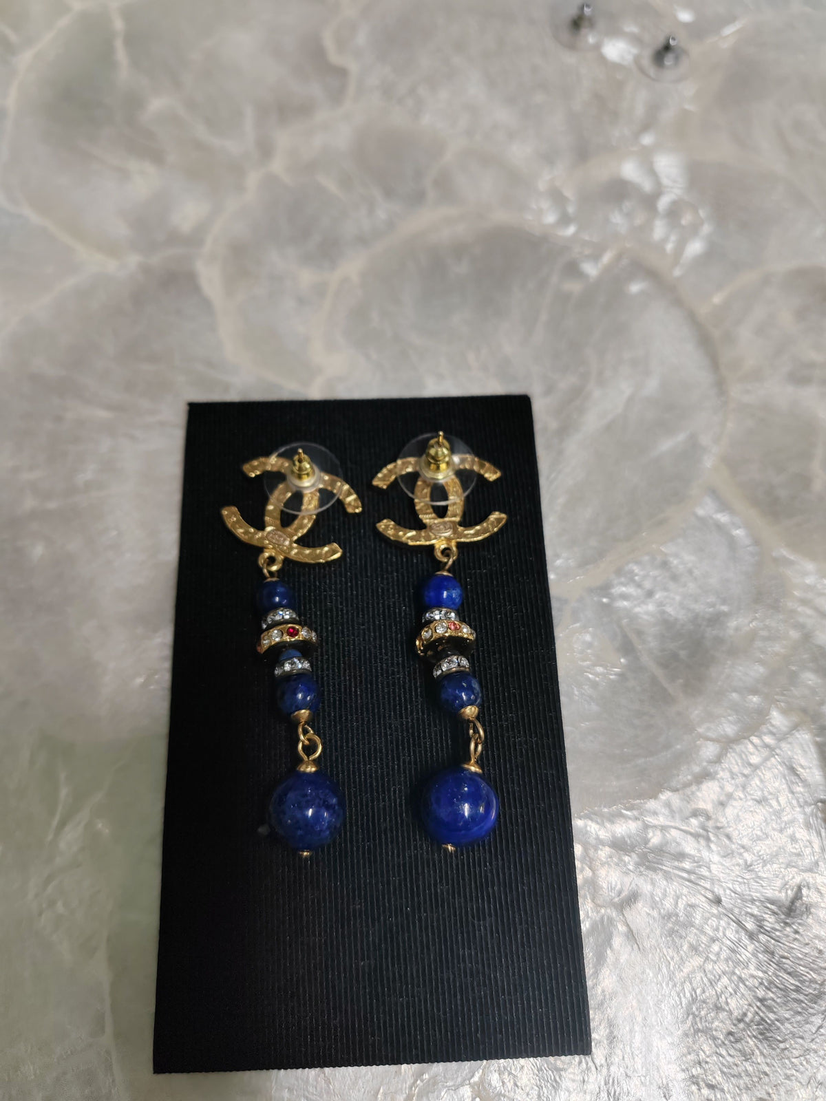 Chanel - Other - Gold-tone metal with blue bead drops and crystal-like accents; exact composition is unconfirmed. - Multicolour