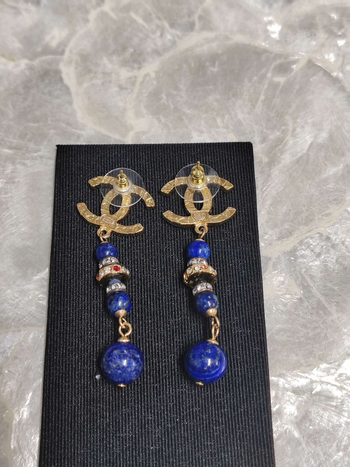 Chanel - Other - Gold-tone metal with blue bead drops and crystal-like accents; exact composition is unconfirmed. - Multicolour