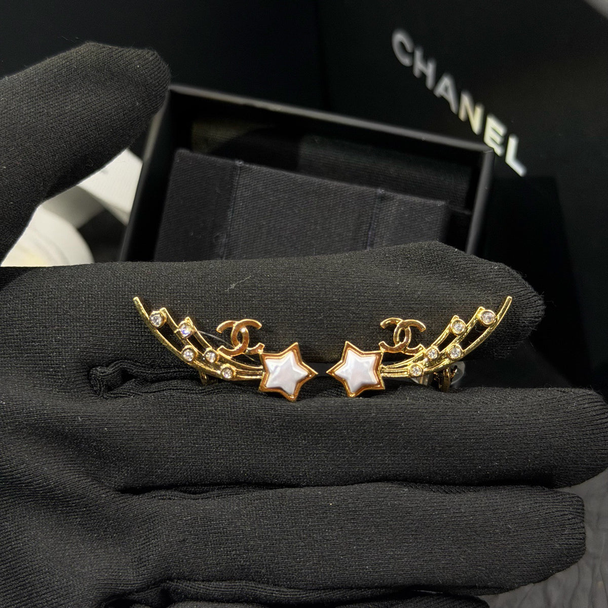 Chanel - Other - Gold-tone metal with clear crystal-like accents and white star-shaped inlays; exact composition unknown. - Gold