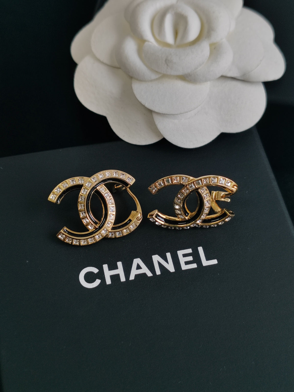 Chanel - Other - Gold-tone metal with clear crystal-like stones and black detailing. - Multicolour