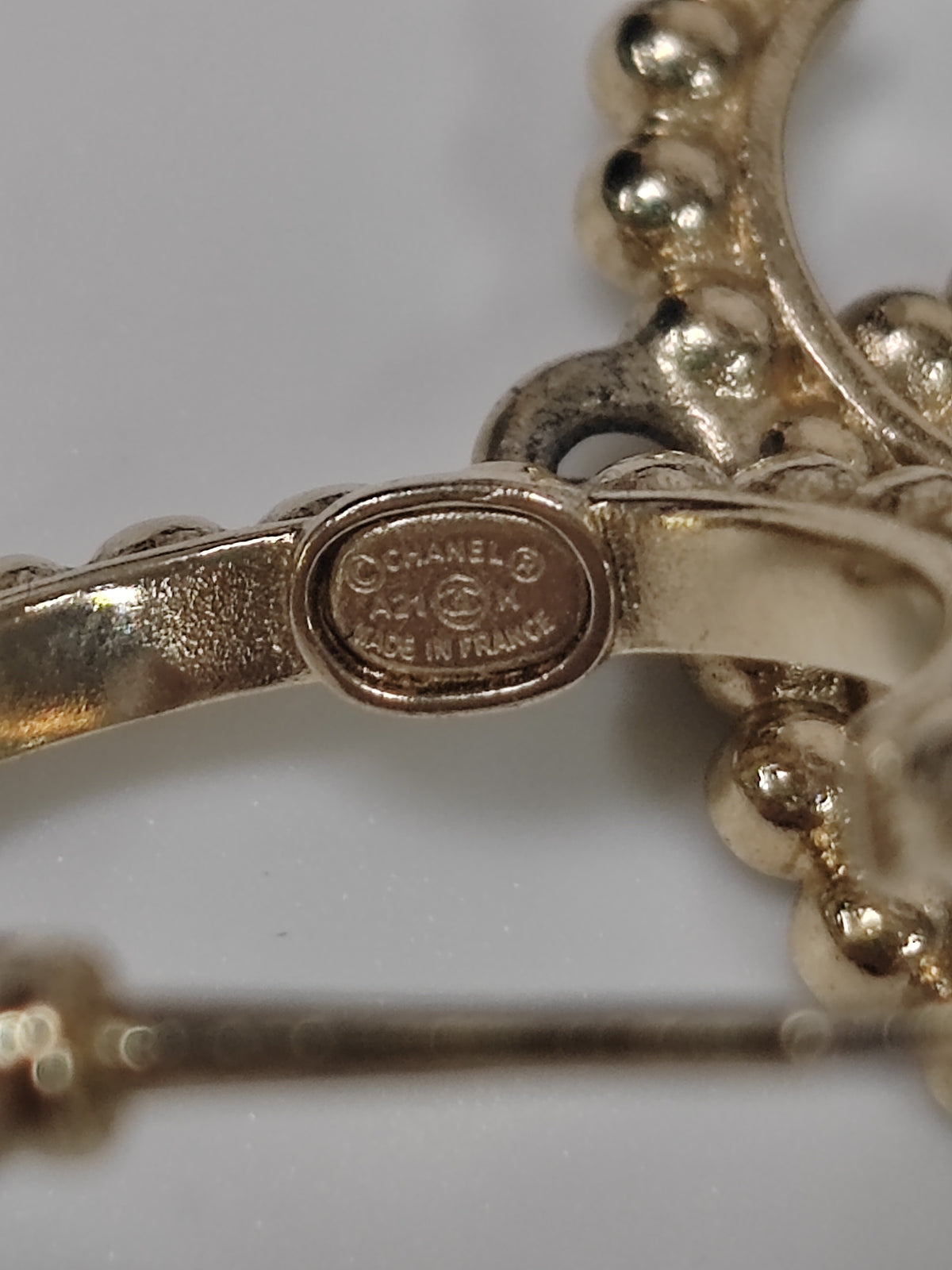 Chanel - Other - Gold-tone metal with clear glass rhinestones, black accents and a faux pearl accent. - Gold
