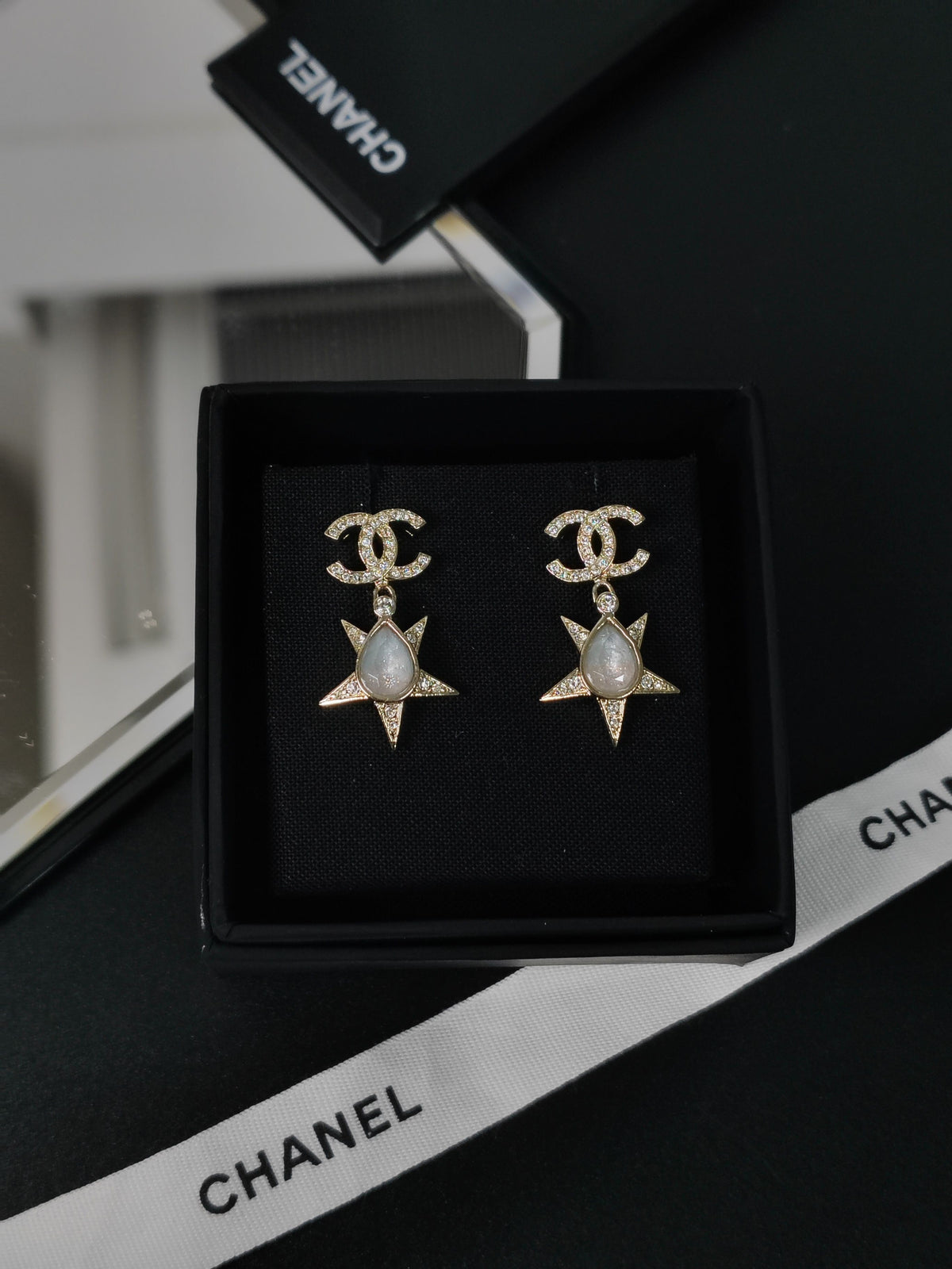 Chanel - Other - Gold-tone metal with clear rhinestone embellishment and grey cabochon-style accents; exact stone composition is not established. - Gold