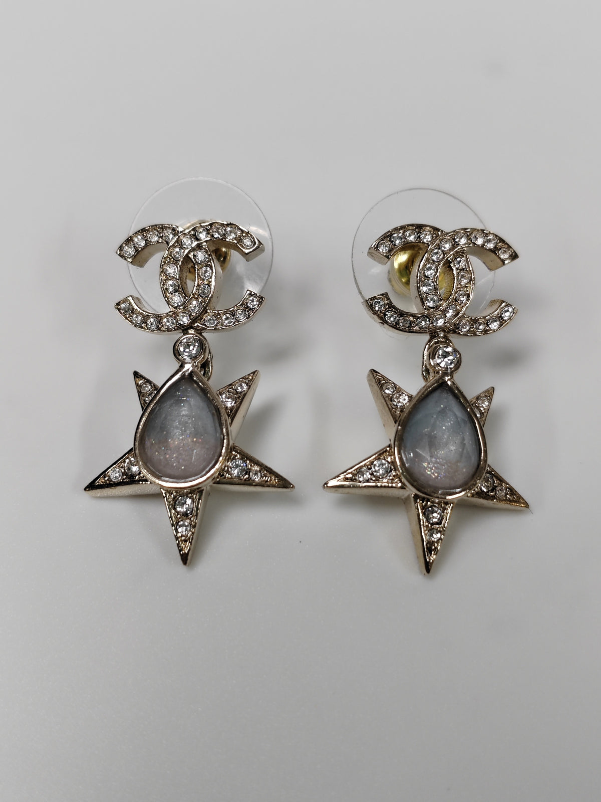 Chanel - Other - Gold-tone metal with clear rhinestone embellishment and grey cabochon-style accents; exact stone composition is not established. - Gold
