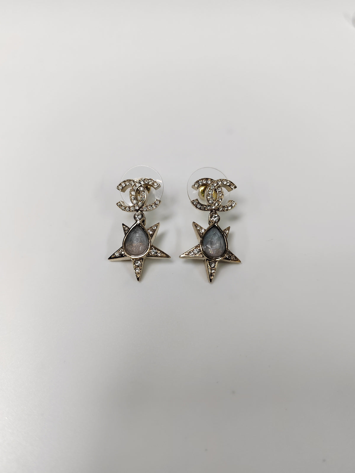Chanel - Other - Gold-tone metal with clear rhinestone embellishment and grey cabochon-style accents; exact stone composition is not established. - Gold