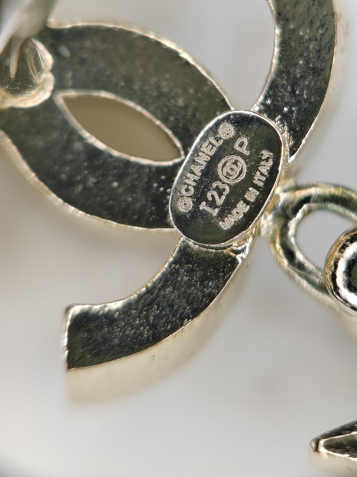 Chanel - Other - Gold-tone metal with clear rhinestone embellishment and grey cabochon-style accents; exact stone composition is not established. - Gold