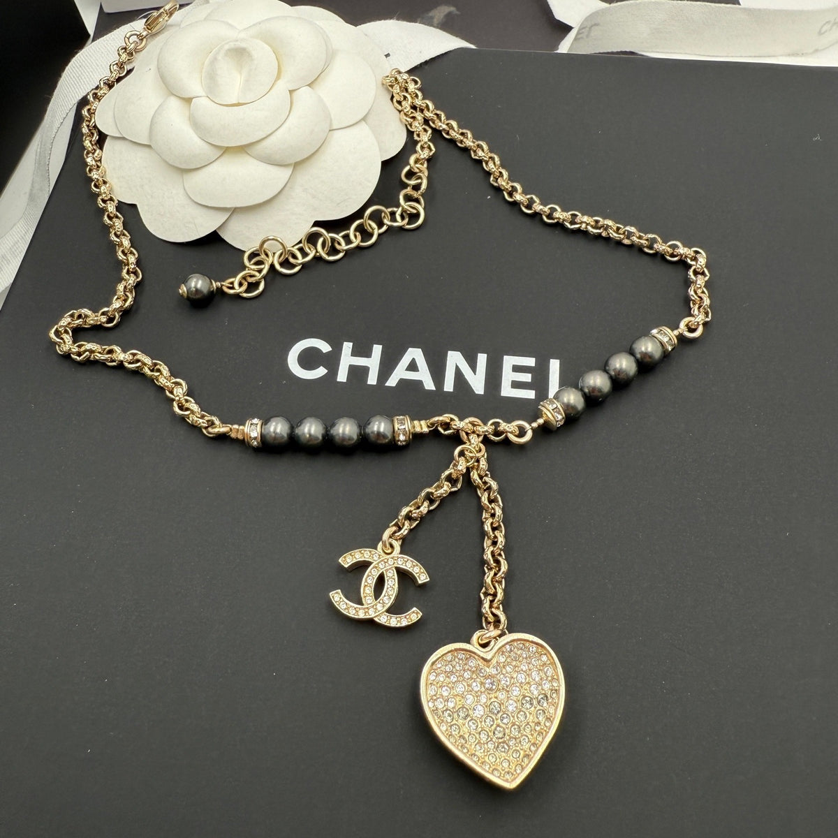 Chanel - Other - Gold-tone metal with dark grey pearl-like beads and clear crystal-like accents; the exact materials of the beads and accents are unspecified. - Gold - (39+7)