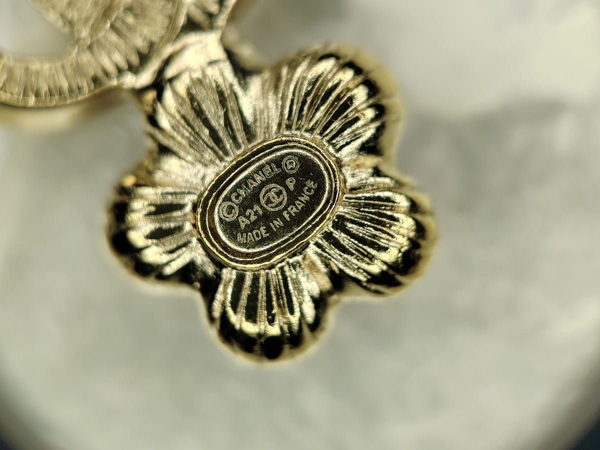 Chanel - Other - Gold-tone metal with glass crystal embellishments, imitation pearls and purple enamel flower accents. - Multicolour