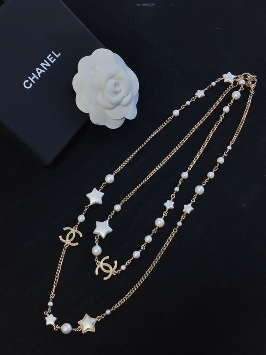 Chanel - Other - Gold-tone metal with imitation pearls and star-shaped resin accents. - Gold