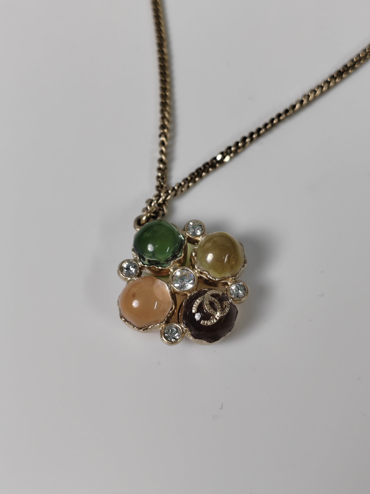 Chanel - Other - Gold-tone metal with multicolour cabochon-style elements and clear faceted accents; exact stone materials are unconfirmed. - Multicolour