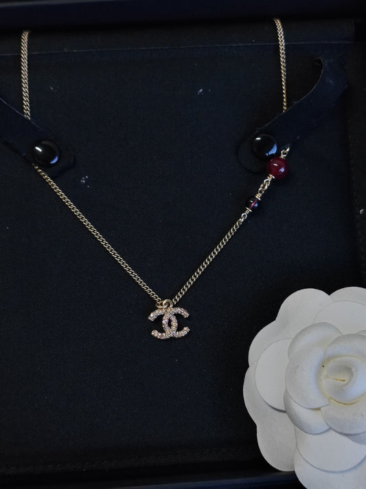 Chanel - Other - Gold-tone metal with purple glass beads and clear rhinestone embellishment; composition not verified. - Multicolour