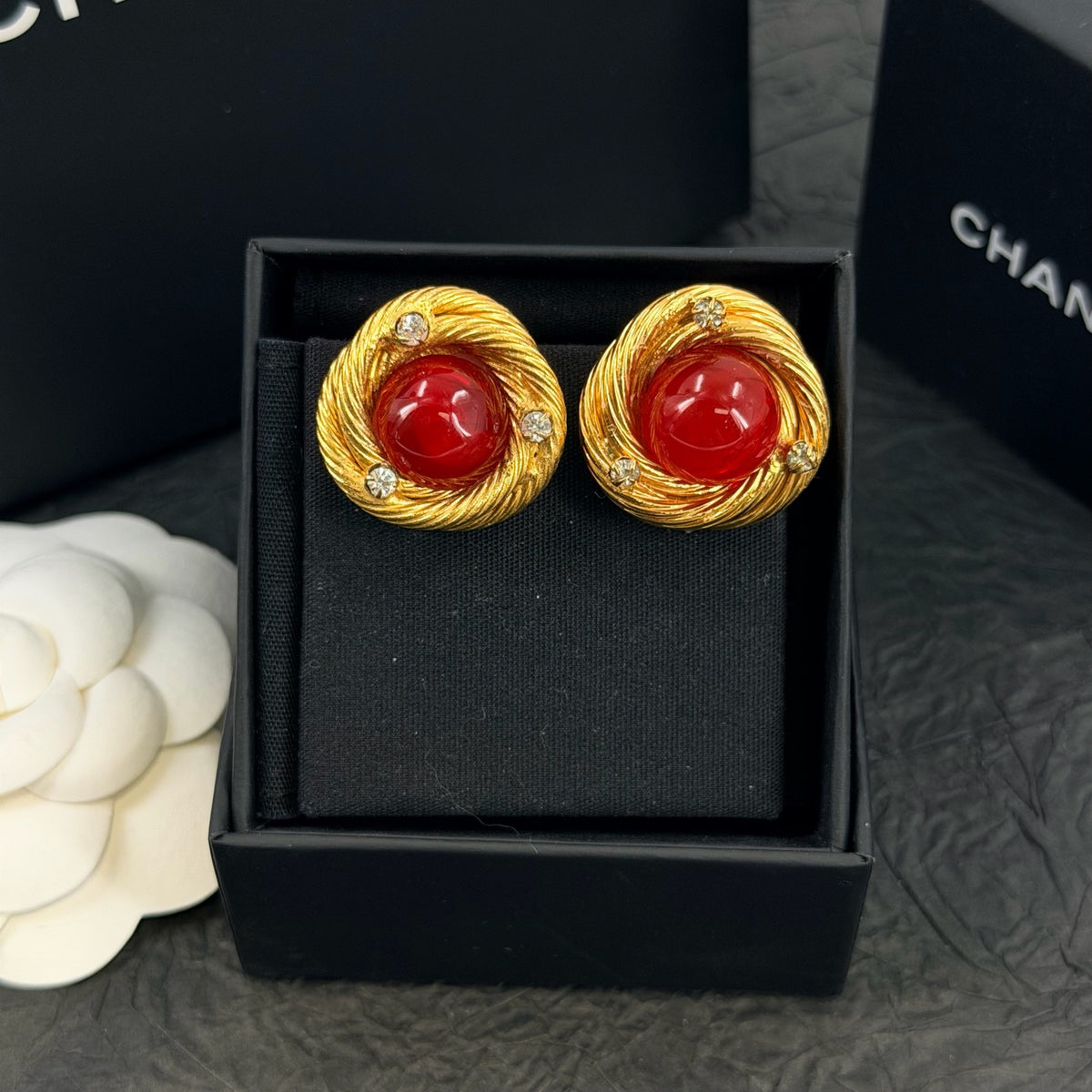 Chanel - Other - Gold-tone metal with red glass cabochons and clear rhinestone accents; exact metal composition is unconfirmed. - Multicolour