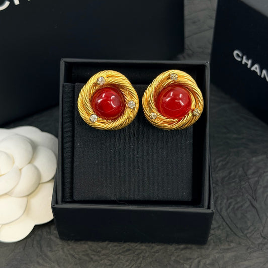 Chanel - Other - Gold-tone metal with red glass cabochons and clear rhinestone accents; exact metal composition is unconfirmed. - Multicolour
