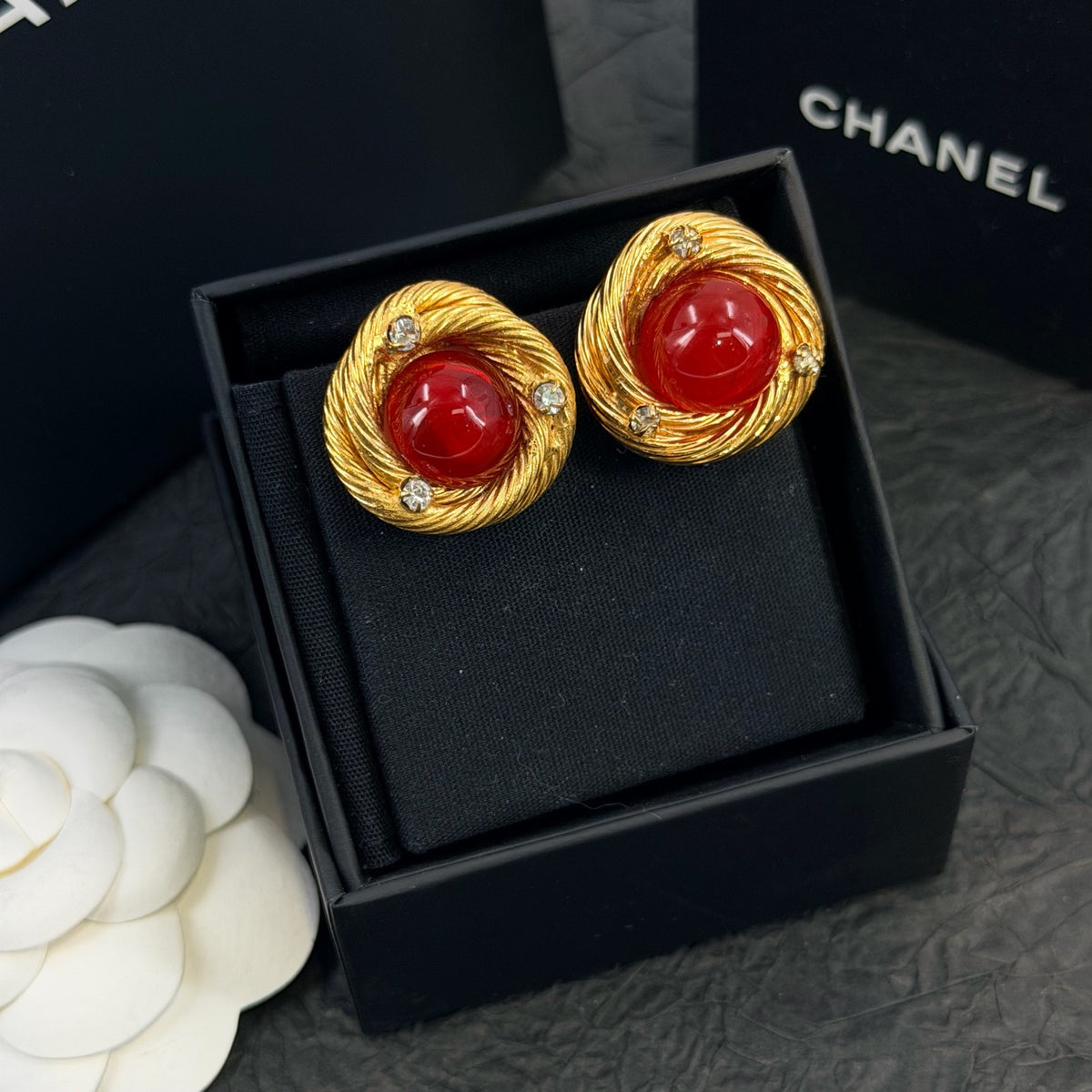 Chanel - Other - Gold-tone metal with red glass cabochons and clear rhinestone accents; exact metal composition is unconfirmed. - Multicolour