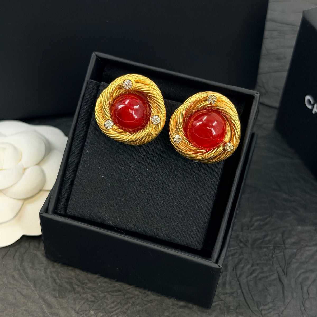 Chanel - Other - Gold-tone metal with red glass cabochons and clear rhinestone accents; exact metal composition is unconfirmed. - Multicolour