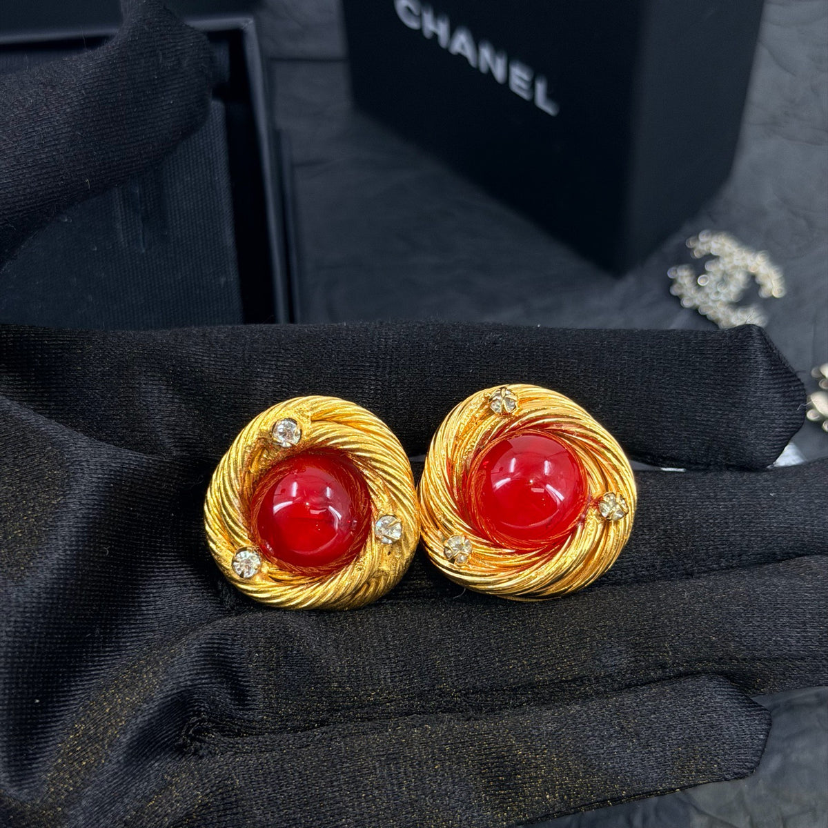 Chanel - Other - Gold-tone metal with red glass cabochons and clear rhinestone accents; exact metal composition is unconfirmed. - Multicolour
