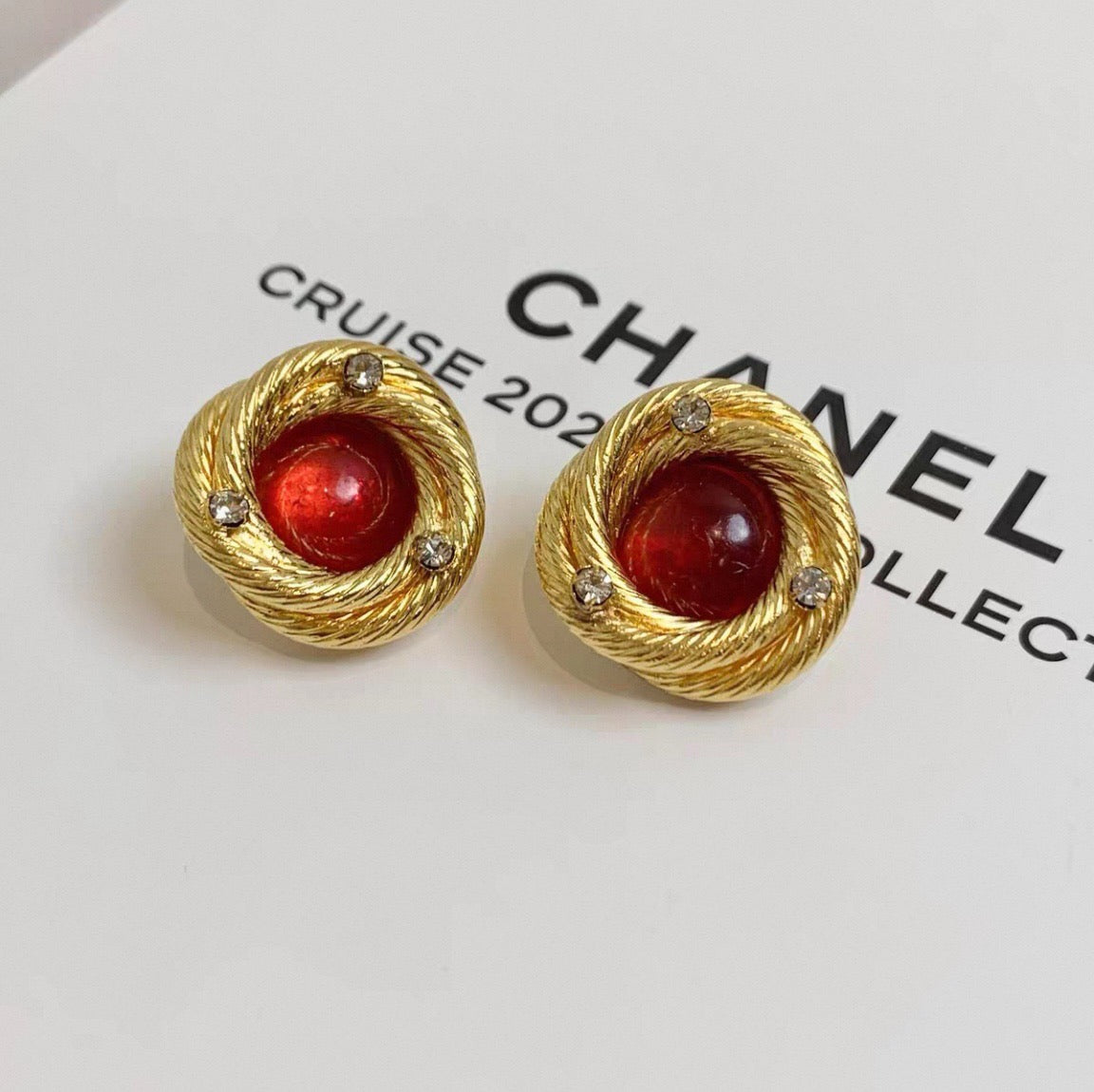Chanel - Other - Gold-tone metal with red glass cabochons and clear rhinestone accents; exact metal composition is unconfirmed. - Multicolour