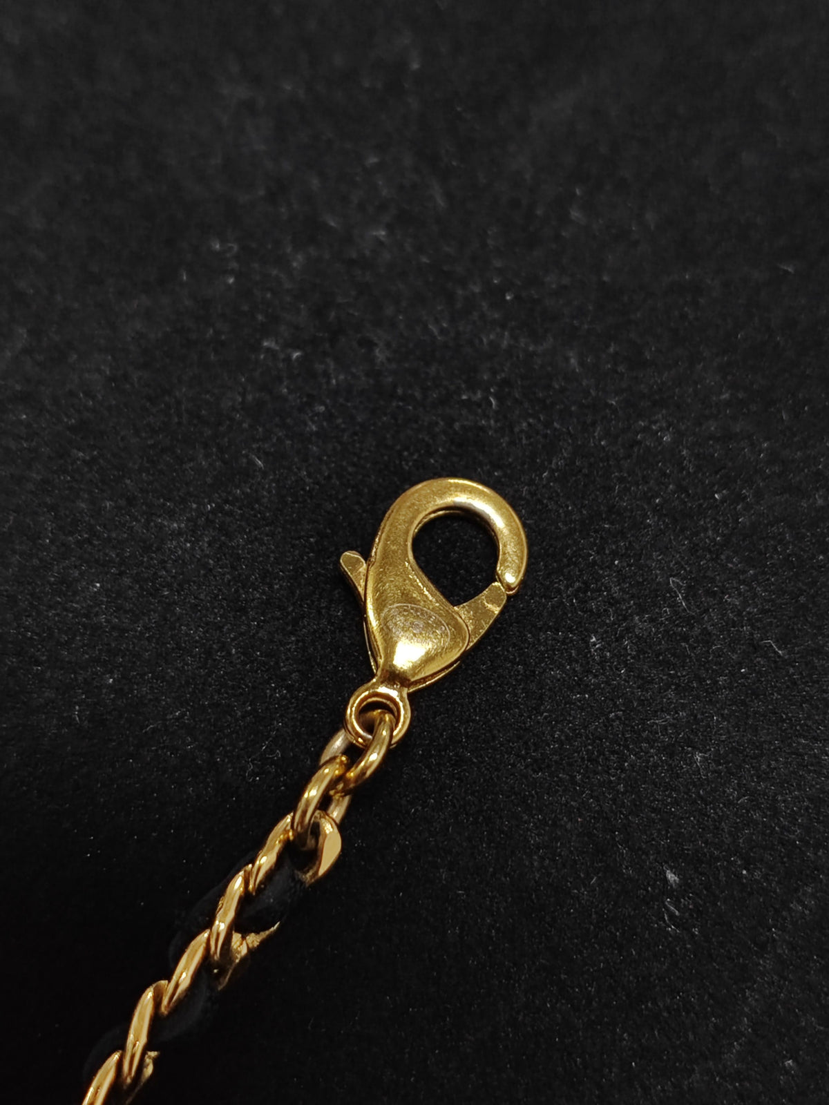 Chanel - Other - Gold-tone metal with rhinestone details and black leather interwoven through the chain. - Gold