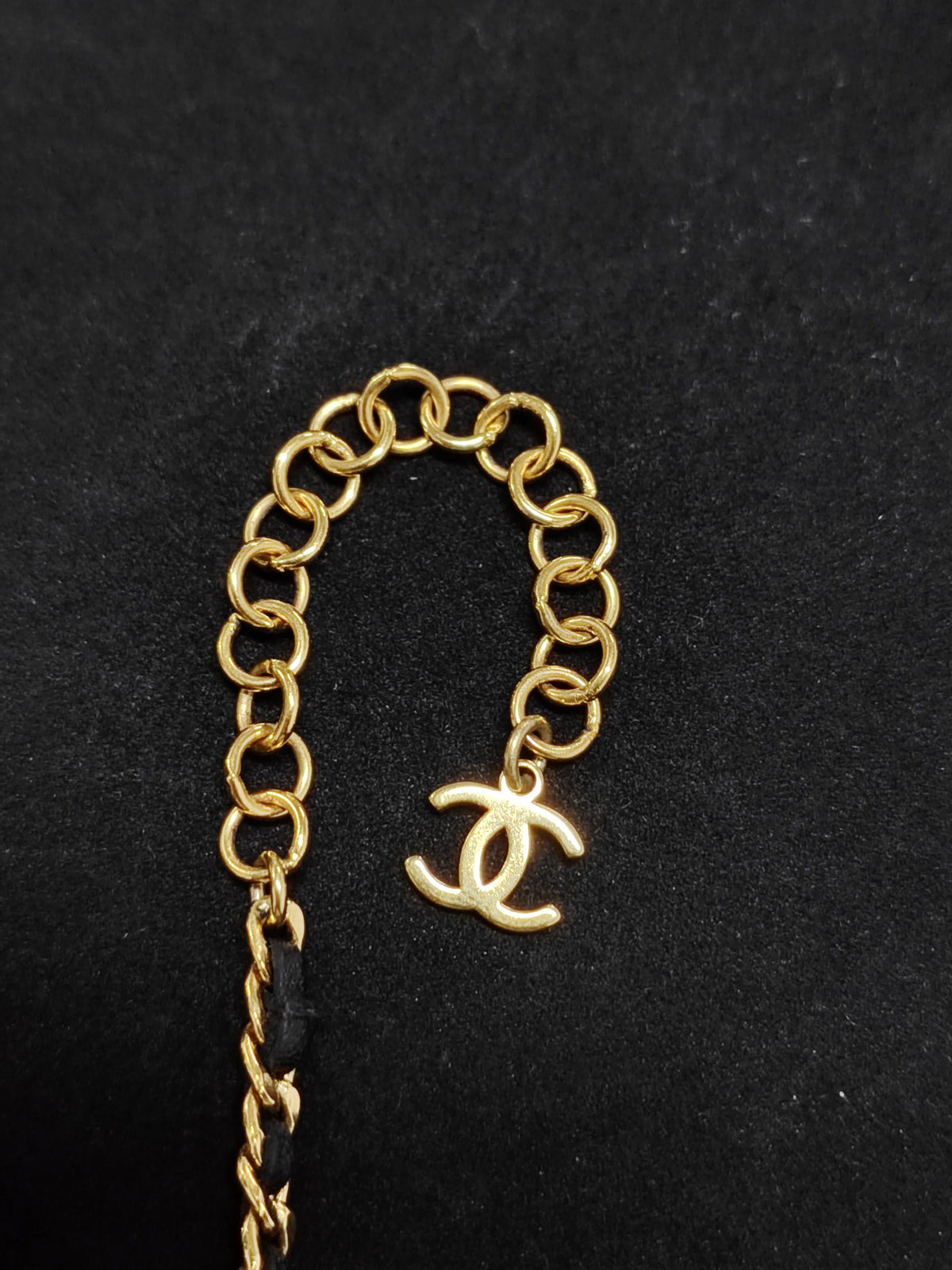 Chanel - Other - Gold-tone metal with rhinestone details and black leather interwoven through the chain. - Gold