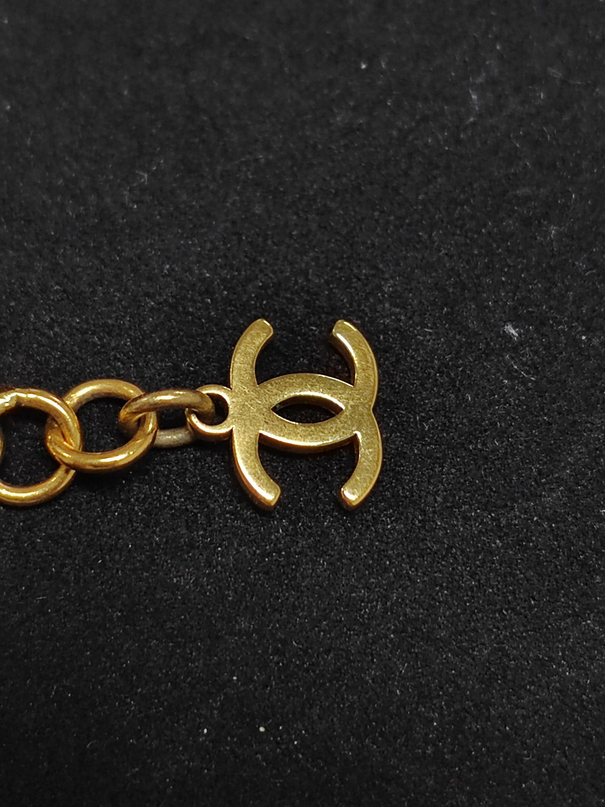 Chanel - Other - Gold-tone metal with rhinestone details and black leather interwoven through the chain. - Gold