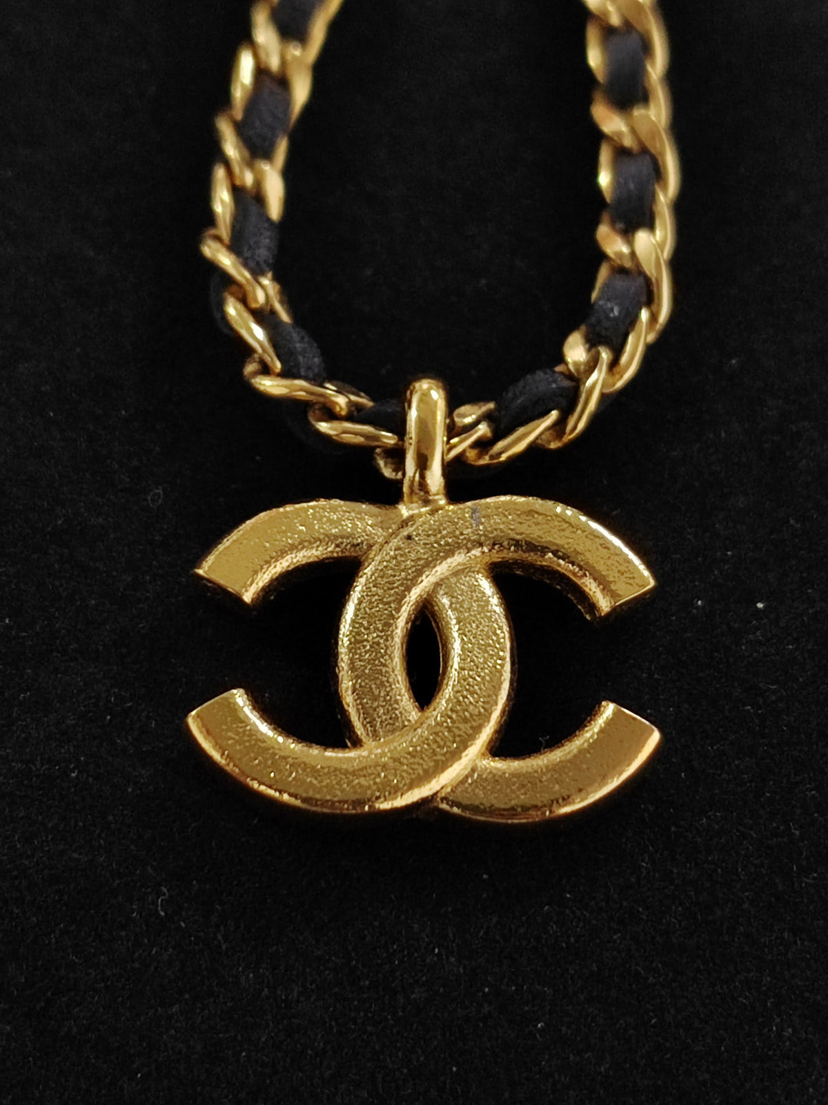 Chanel - Other - Gold-tone metal with rhinestone details and black leather interwoven through the chain. - Gold