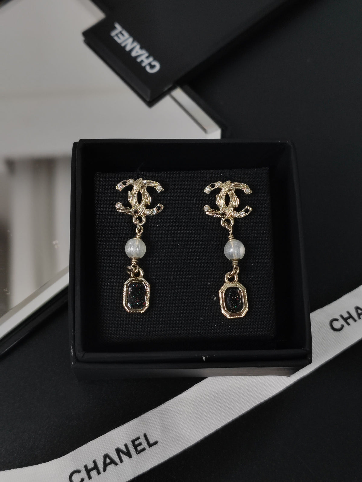 Chanel - Other - Gold-tone metal with rhinestone-style stones and pearl-like and black decorative elements; exact stone and pearl composition is not confirmed. - Multicolour