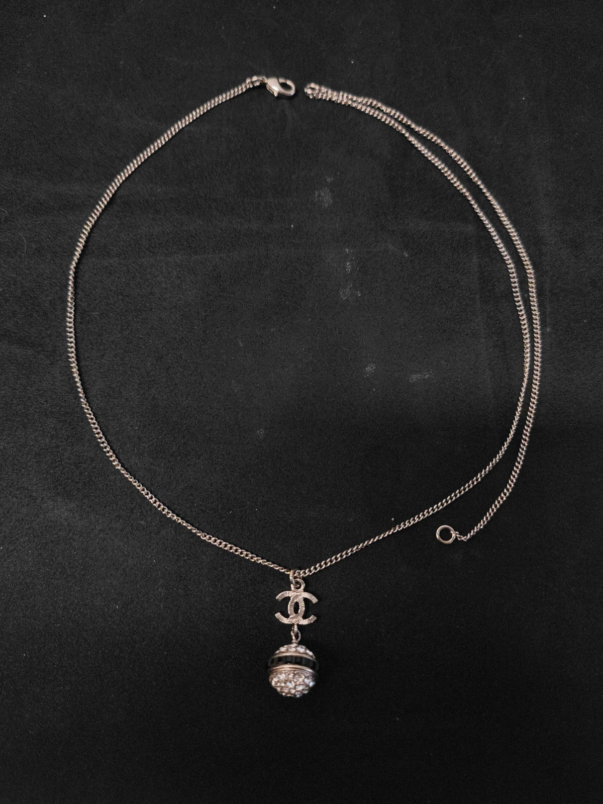 Chanel - Other - Metal base with clear rhinestone embellishment and dark accent details; exact composition is unconfirmed. - Silver