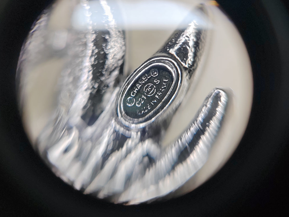 Chanel - Other - Silver-tone base metal with clear rhinestone embellishments. - Silver