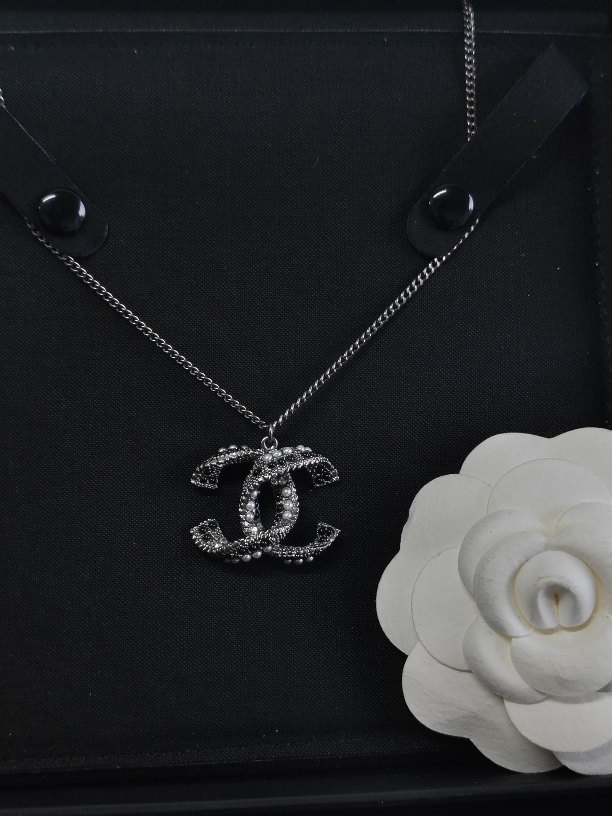 Chanel - Other - Silver-tone base metal with pearl-like and dark decorative accents; exact composition is not confirmed. - Silver