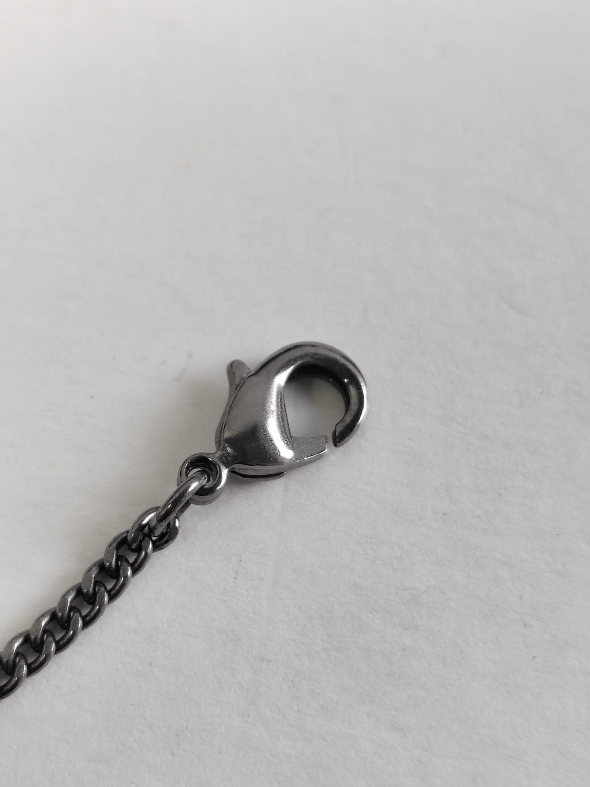 Chanel - Other - Silver-tone base metal with pearl-like and dark decorative accents; exact composition is not confirmed. - Silver