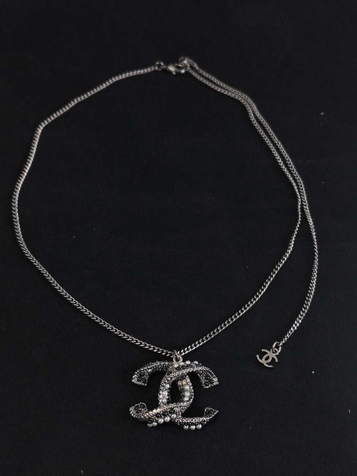 Chanel - Other - Silver-tone base metal with pearl-like and dark decorative accents; exact composition is not confirmed. - Silver