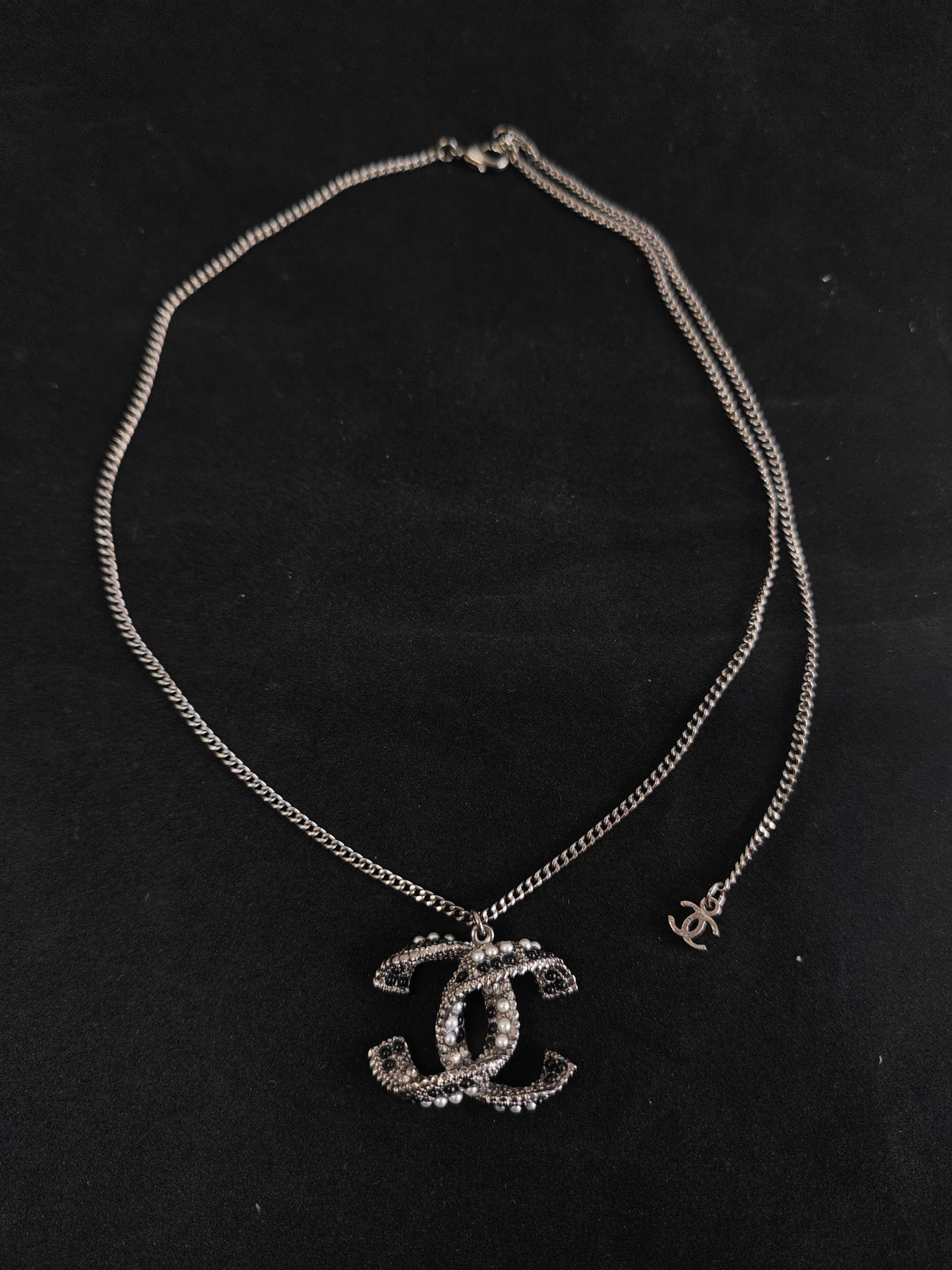Chanel - Other - Silver-tone base metal with pearl-like and dark decorative accents; exact composition is not confirmed. - Silver