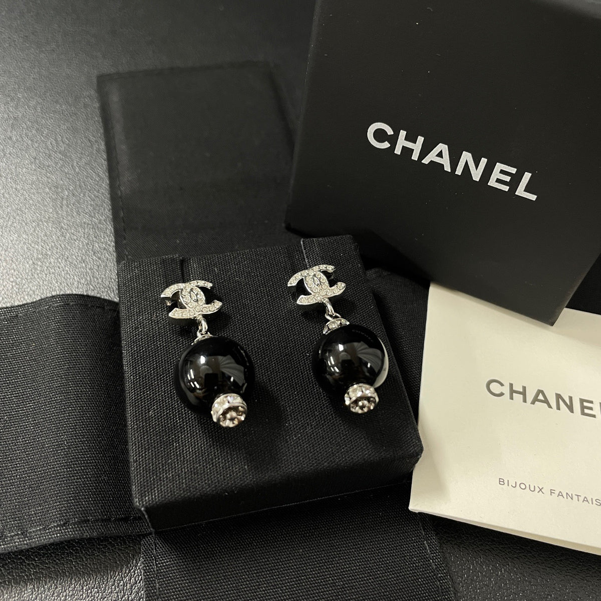 Chanel - Other - Silver-tone costume-jewellery metal with clear rhinestone accents and glossy black bead drops; exact stone and bead compositions are unconfirmed. - Multicolour
