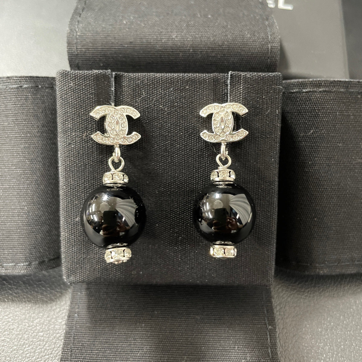 Chanel - Other - Silver-tone costume-jewellery metal with clear rhinestone accents and glossy black bead drops; exact stone and bead compositions are unconfirmed. - Multicolour