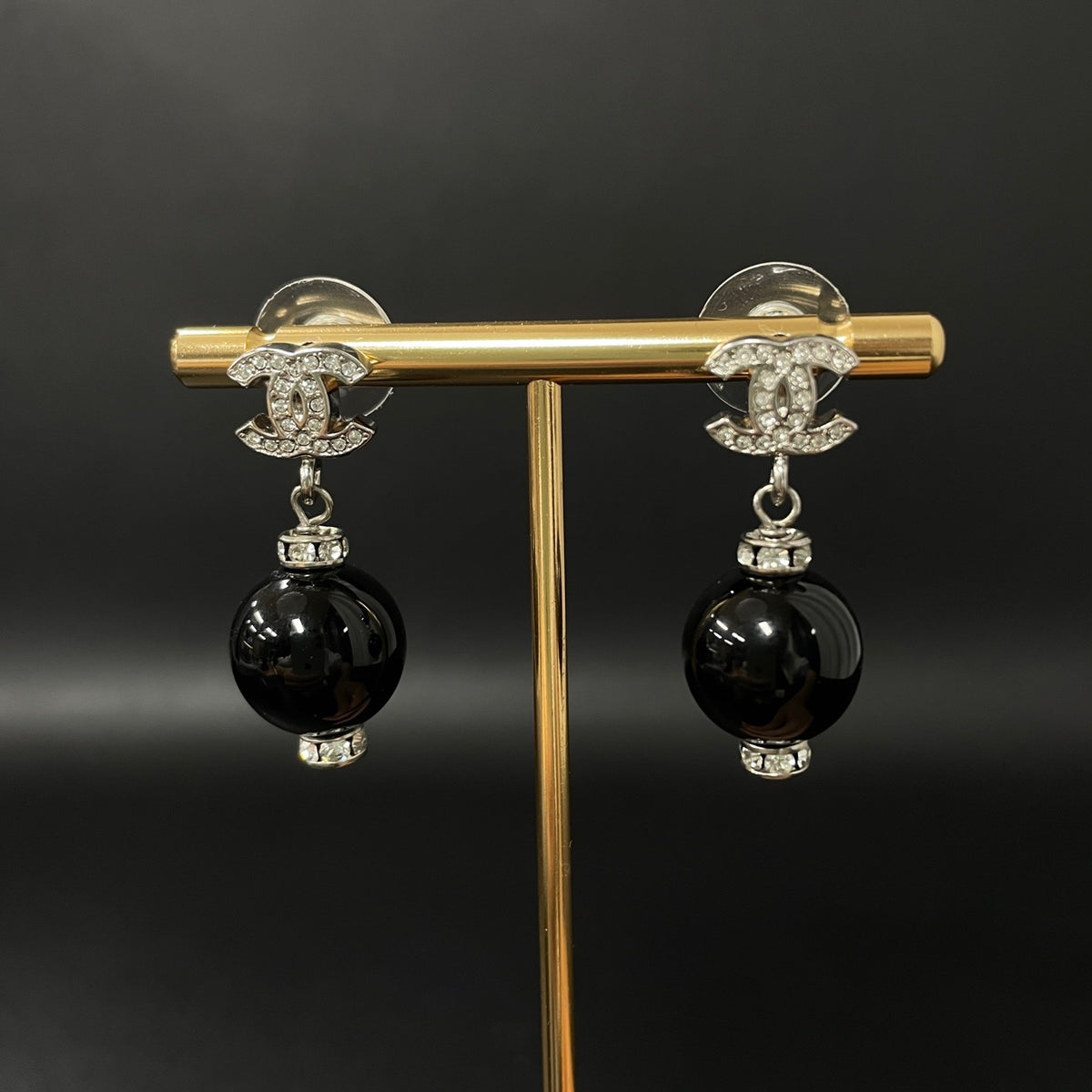 Chanel - Other - Silver-tone costume-jewellery metal with clear rhinestone accents and glossy black bead drops; exact stone and bead compositions are unconfirmed. - Multicolour