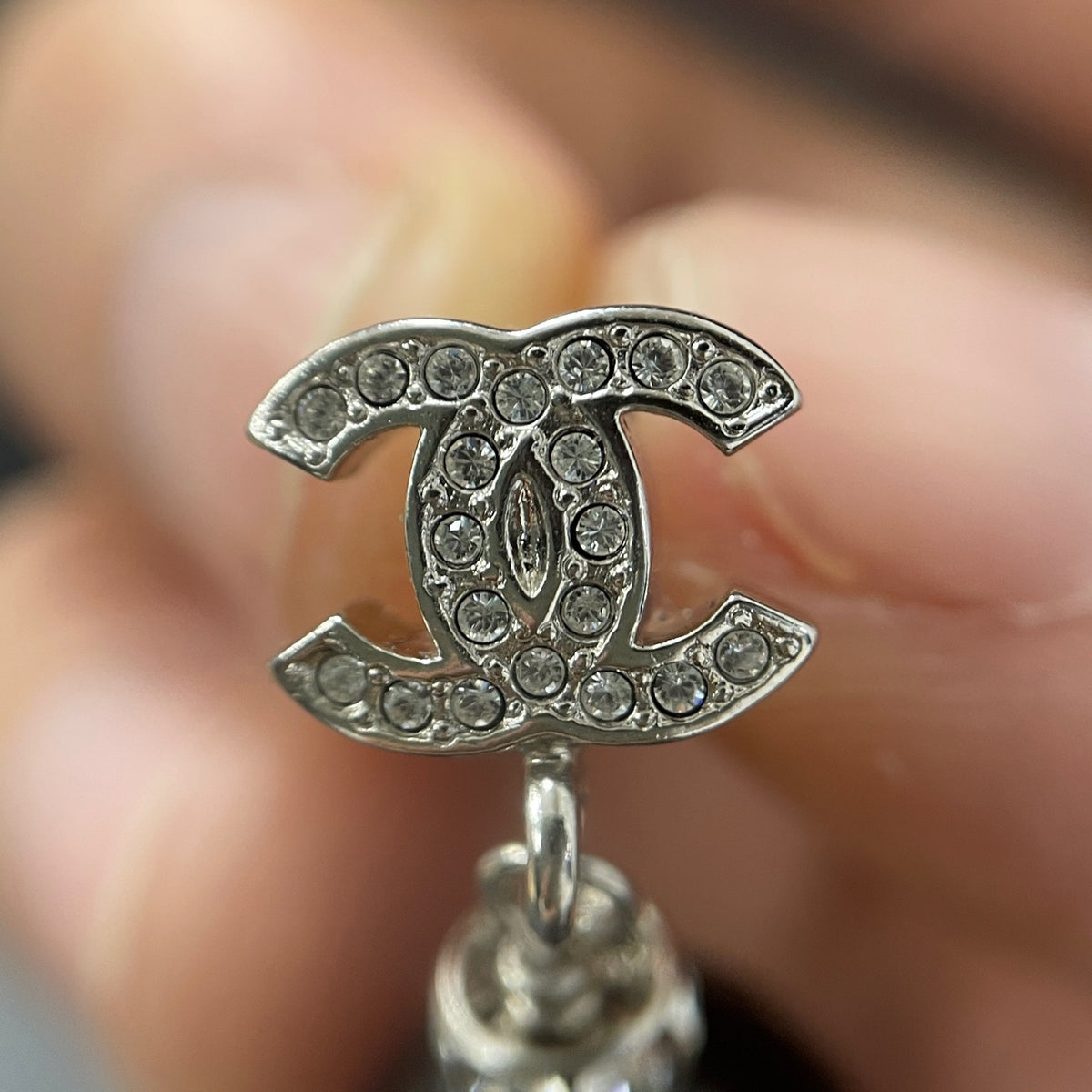 Chanel - Other - Silver-tone costume-jewellery metal with clear rhinestone accents and glossy black bead drops; exact stone and bead compositions are unconfirmed. - Multicolour