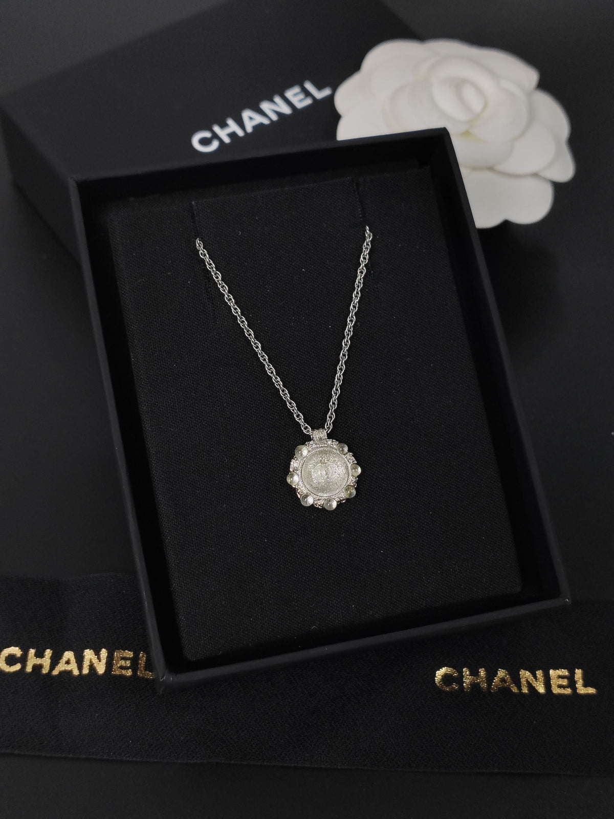 Chanel - Other - Silver-tone metal alloy with clear rhinestone accents and dark round decorative beads. - Silver