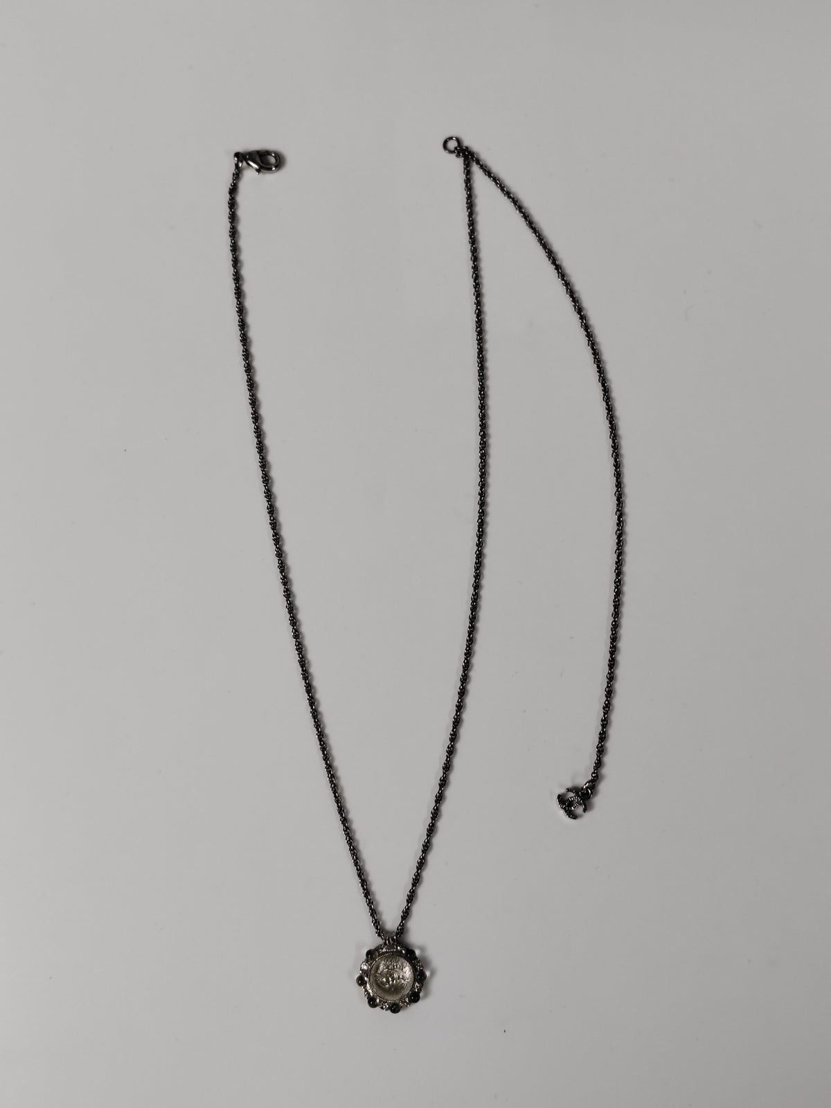 Chanel - Other - Silver-tone metal alloy with clear rhinestone accents and dark round decorative beads. - Silver