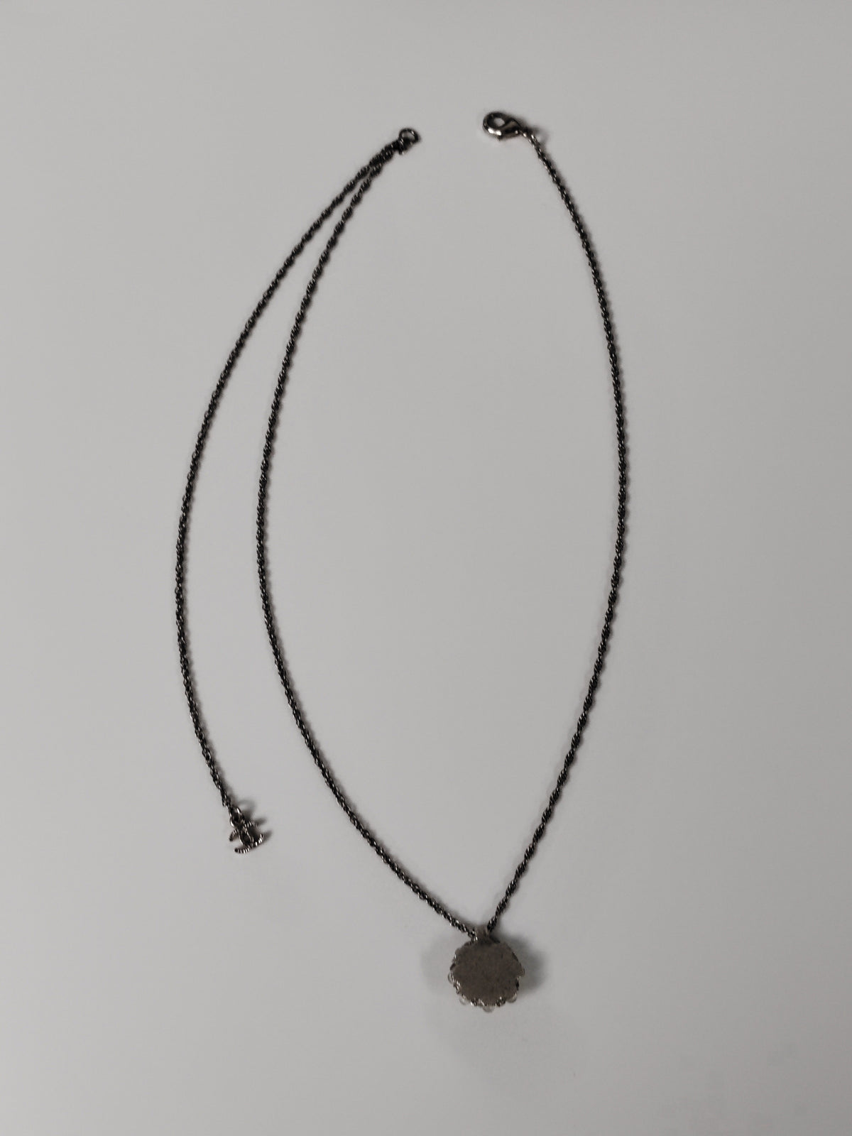 Chanel - Other - Silver-tone metal alloy with clear rhinestone accents and dark round decorative beads. - Silver